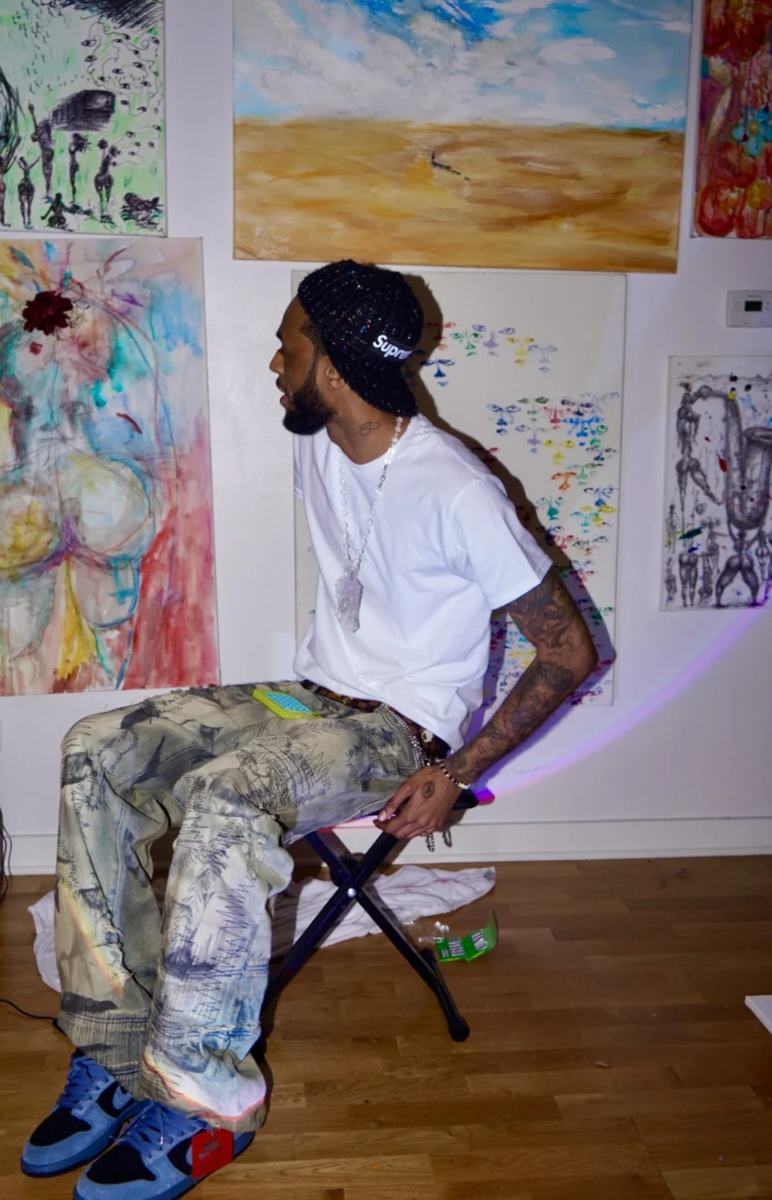 Justin White Foreva with his artwork